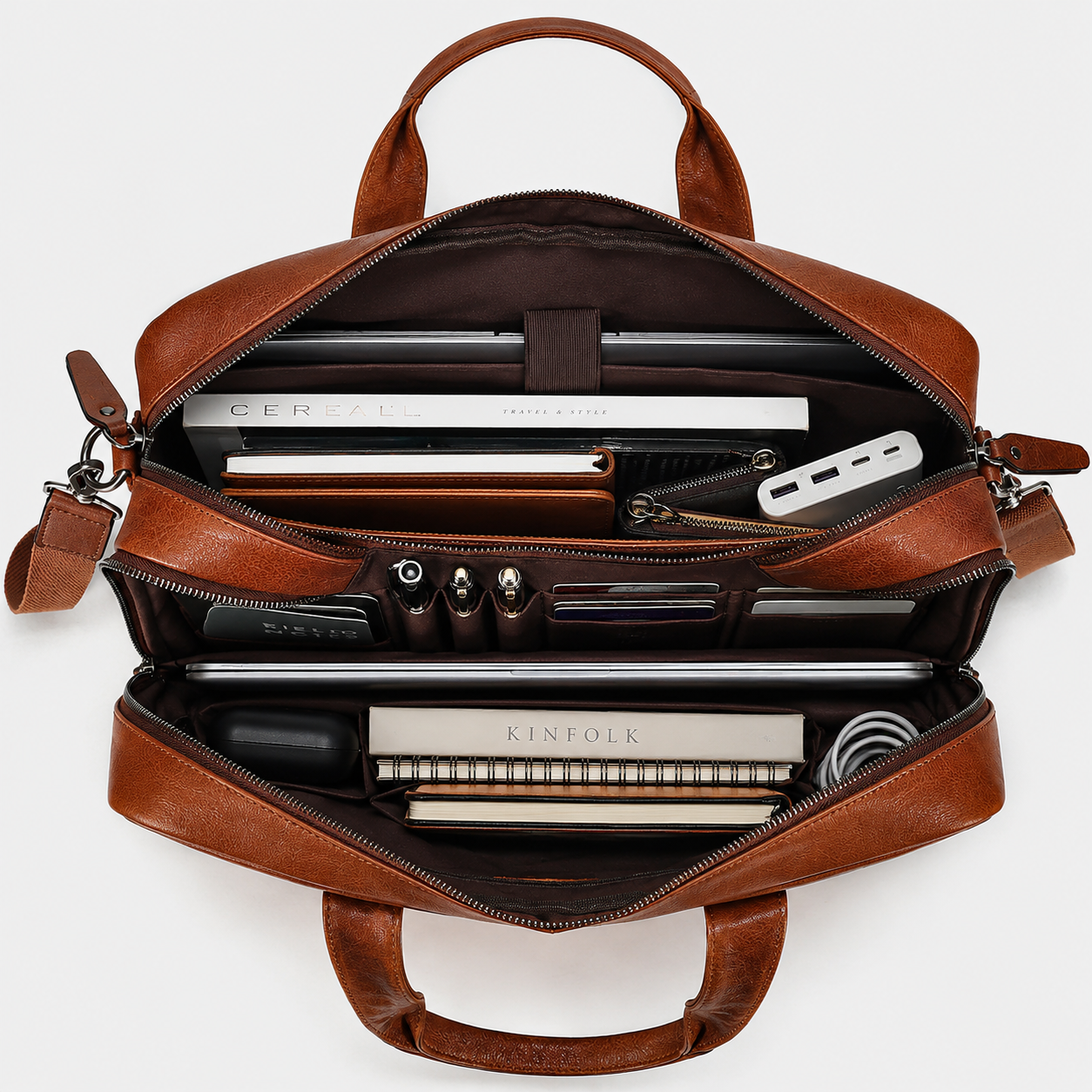 Interior of leather messenger bag showing padded laptop compartment and organized storage pockets.