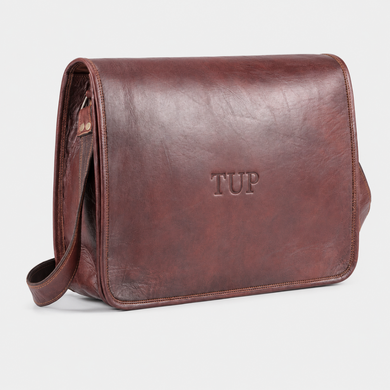 Brown full-grain leather messenger bag with magnetic flap closure and adjustable shoulder strap for business and everyday use.