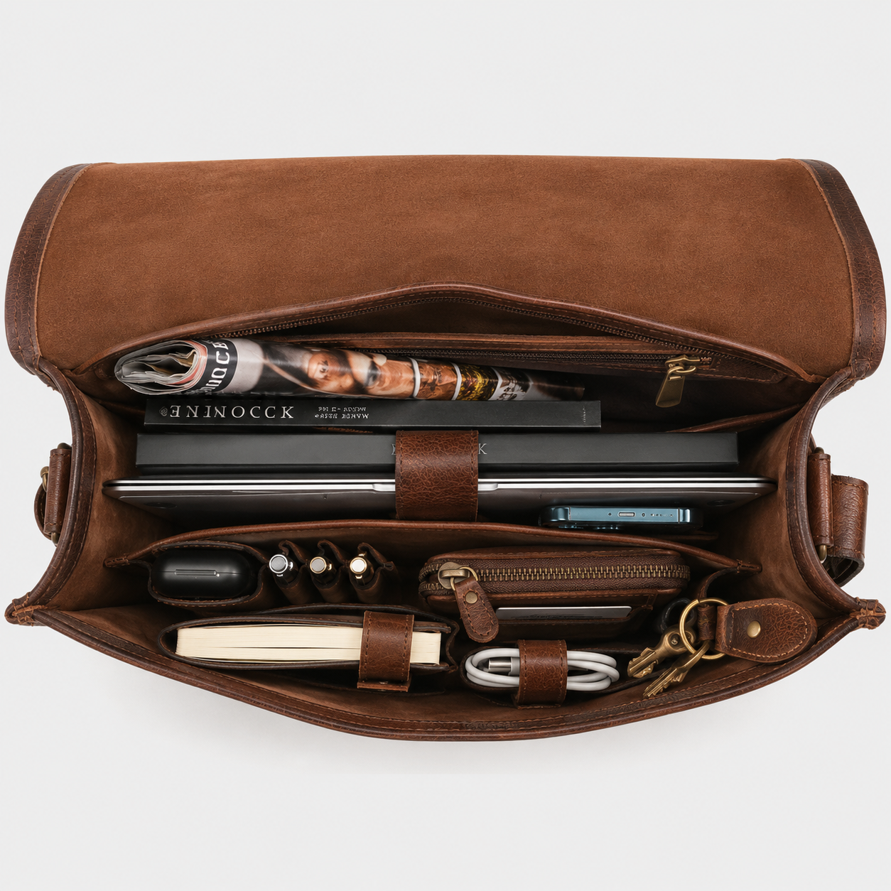 Interior view of leather messenger bag with padded laptop compartment and organized storage pockets.