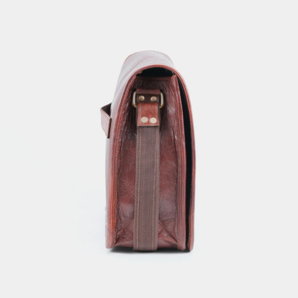 Side profile of premium leather messenger bag showcasing handcrafted full-grain leather.