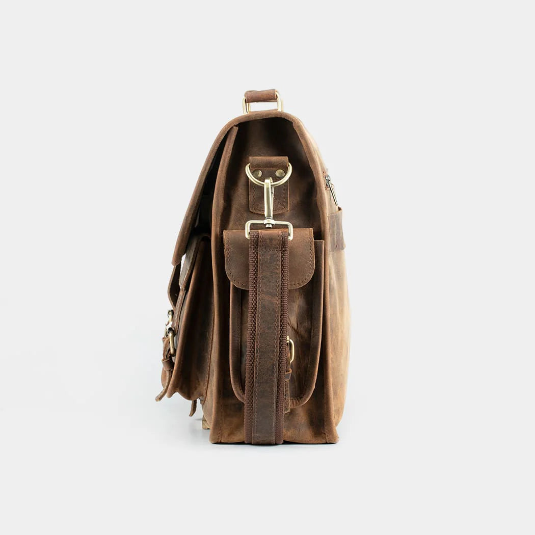 Side profile of handcrafted leather messenger bag showing premium stitching and durable construction.