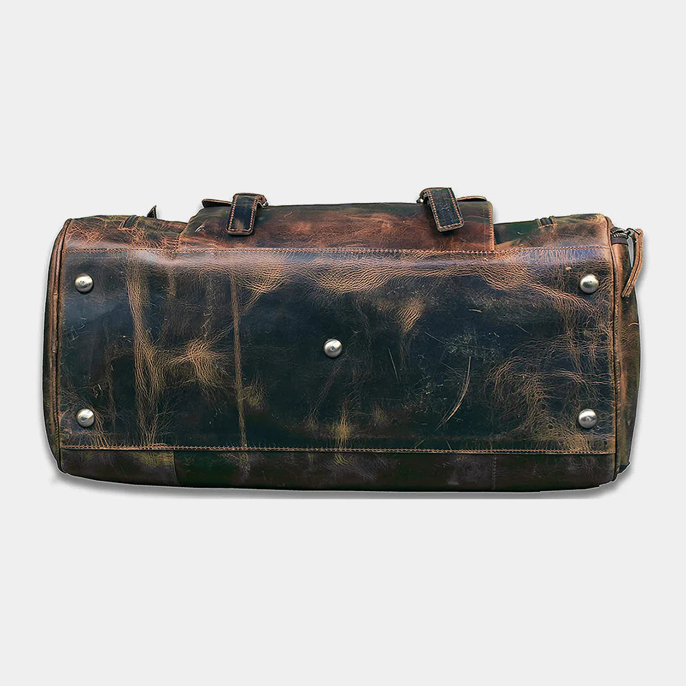 Side profile of handcrafted buffalo leather travel duffle with vintage distressed finish
