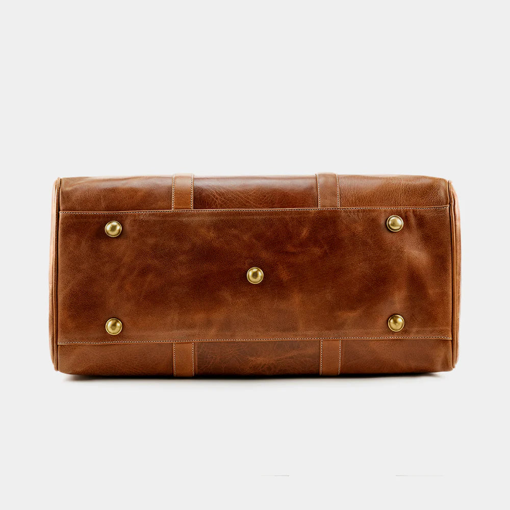 Bottom view of The Hudson leather duffle bag with protective brass feet.