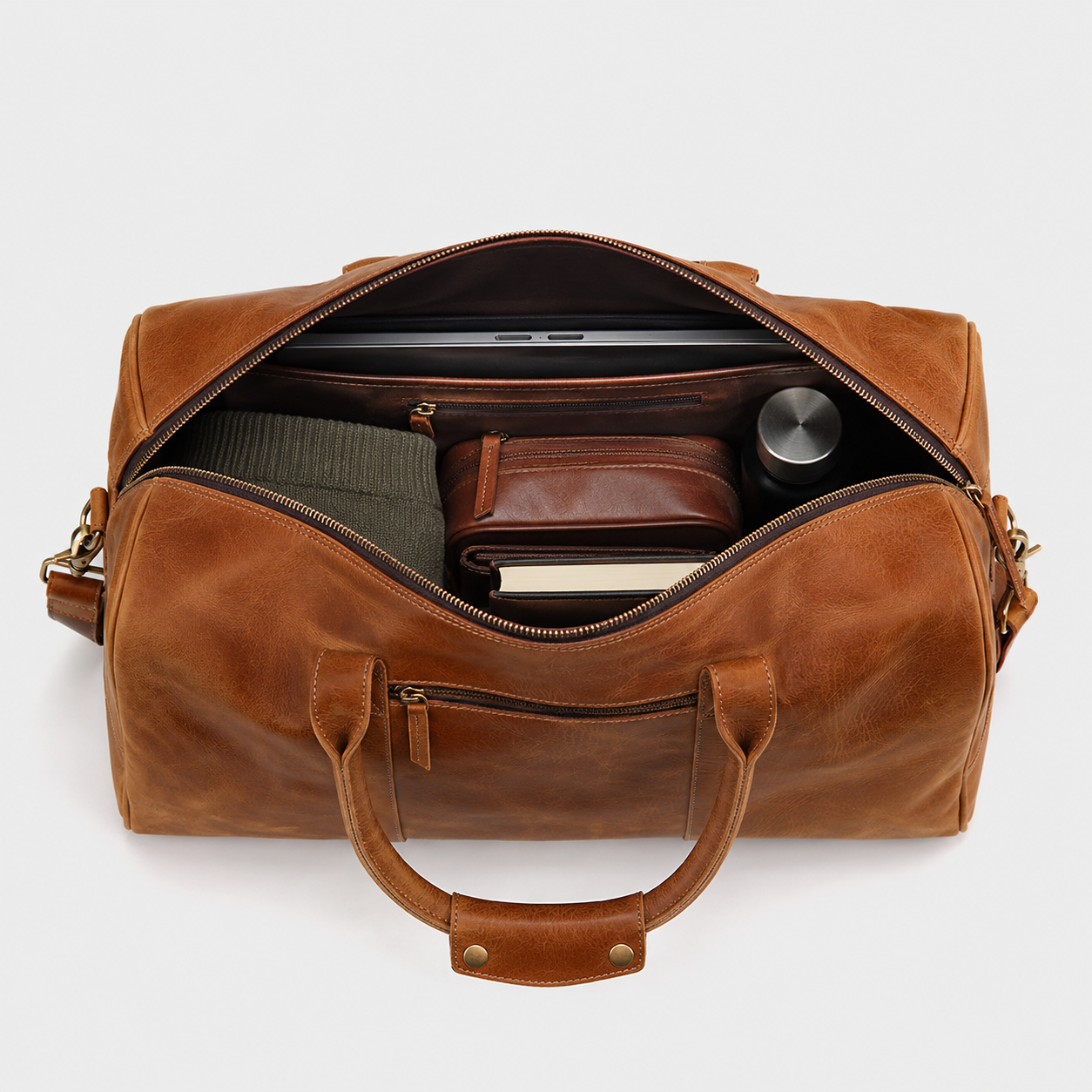 Spacious interior of The Hudson leather duffle bag with organized compartments for travel essentials.
