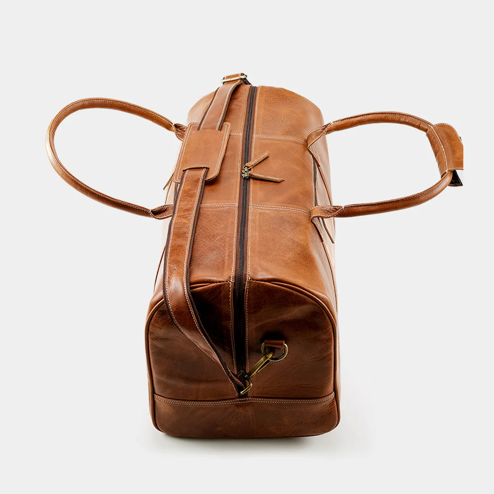 Side profile of The Hudson leather travel bag showing structured weekender design.