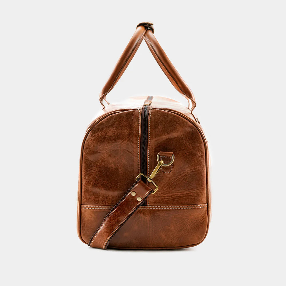 Side profile of The Hudson leather travel bag showing structured weekender design.