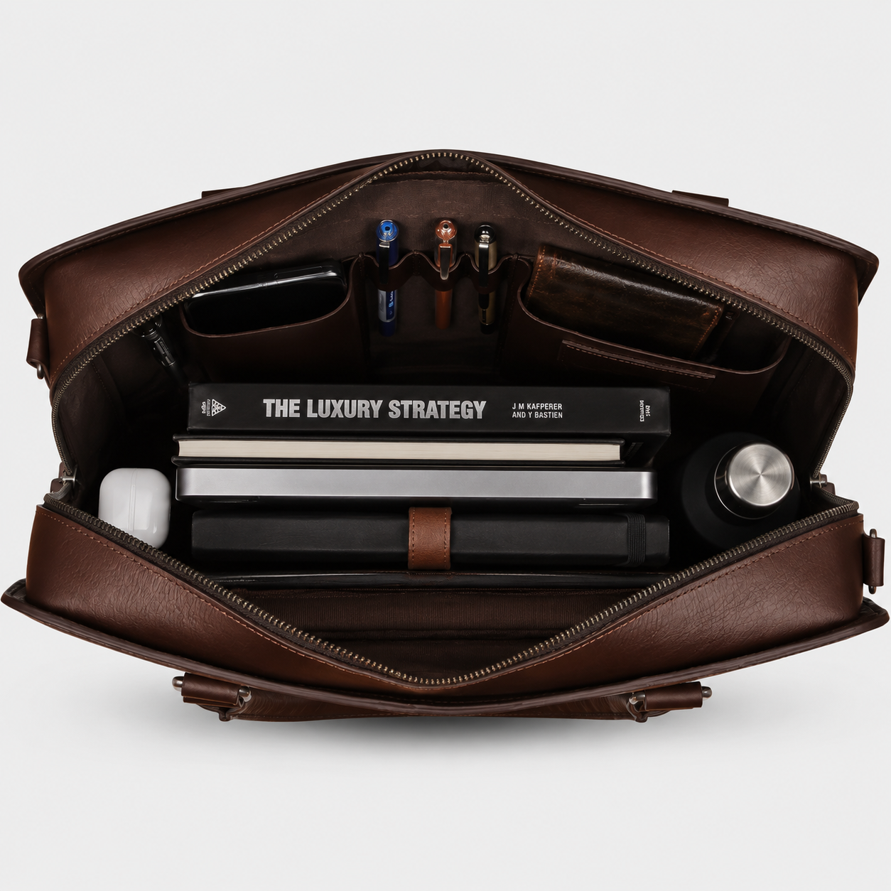 Interior of leather briefcase showing padded laptop compartment, organizer pockets, and spacious storage.