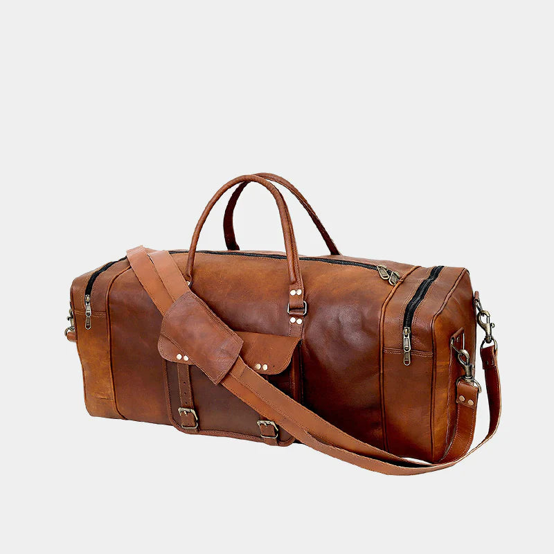 Angled view of extra large leather weekender bag with adjustable shoulder strap