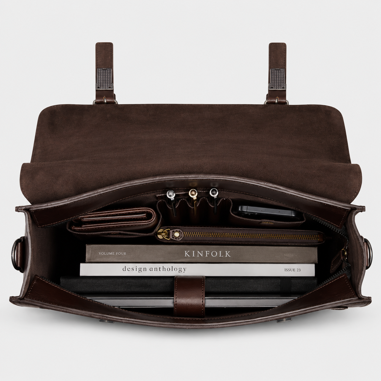 Interior of leather briefcase featuring padded laptop sleeve, organizer pockets, and spacious compartments.