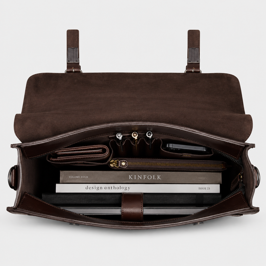 Interior of leather briefcase featuring padded laptop sleeve, organizer pockets, and spacious compartments.