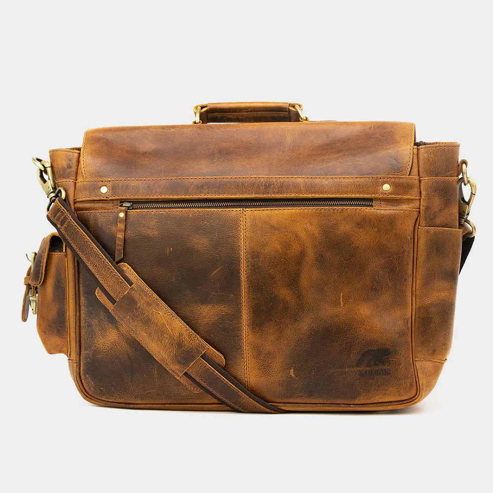 Side profile of vintage leather messenger bag with adjustable shoulder strap.