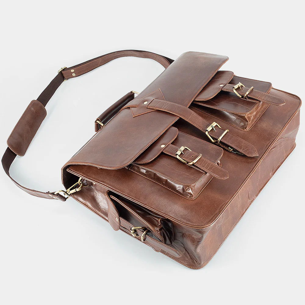 Open leather messenger bag displaying organized interior with padded laptop compartment and storage pockets.