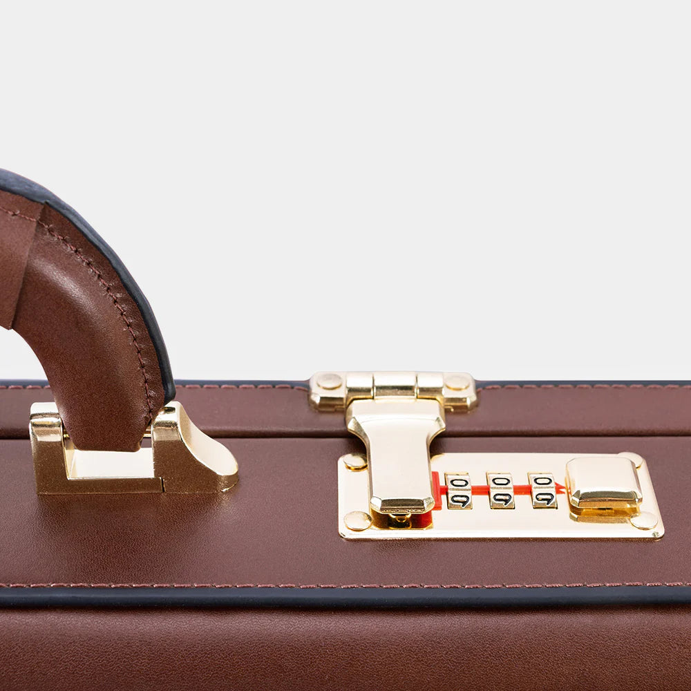 Premium metal lock detail on The Sovereign luxury leather briefcase.