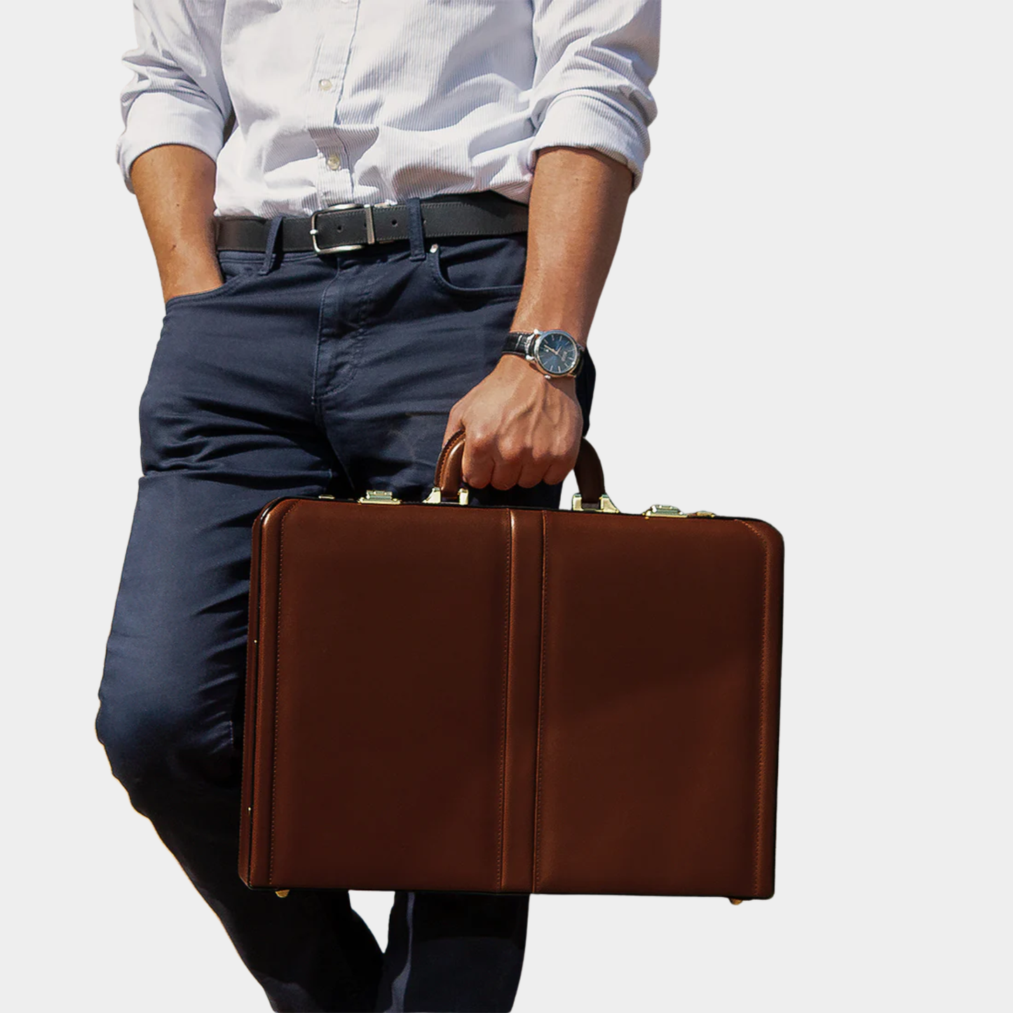 Executive carrying The Sovereign leather briefcase during business travel.