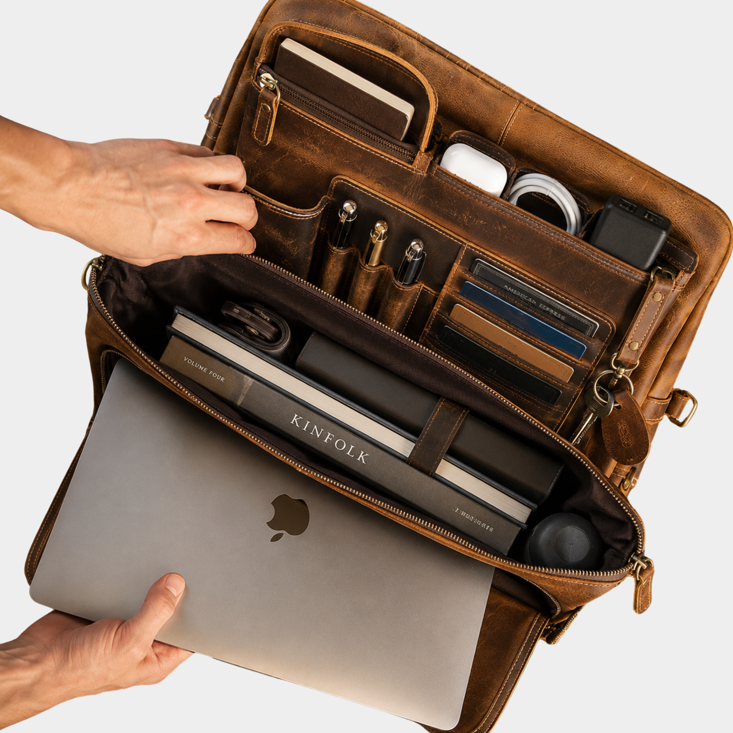 Interior of leather work bag with organized compartments and padded laptop storage.