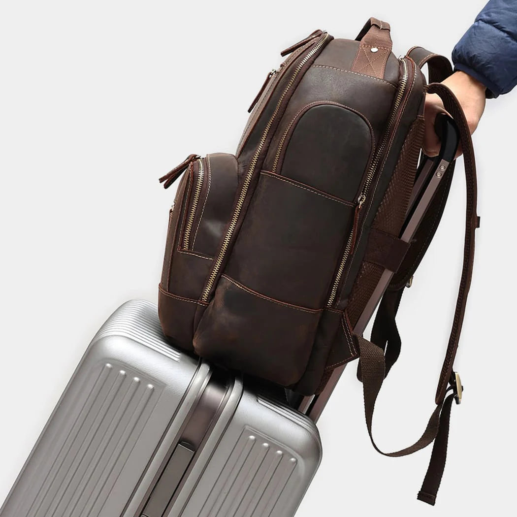 Leather backpack attached to rolling luggage using rear luggage strap