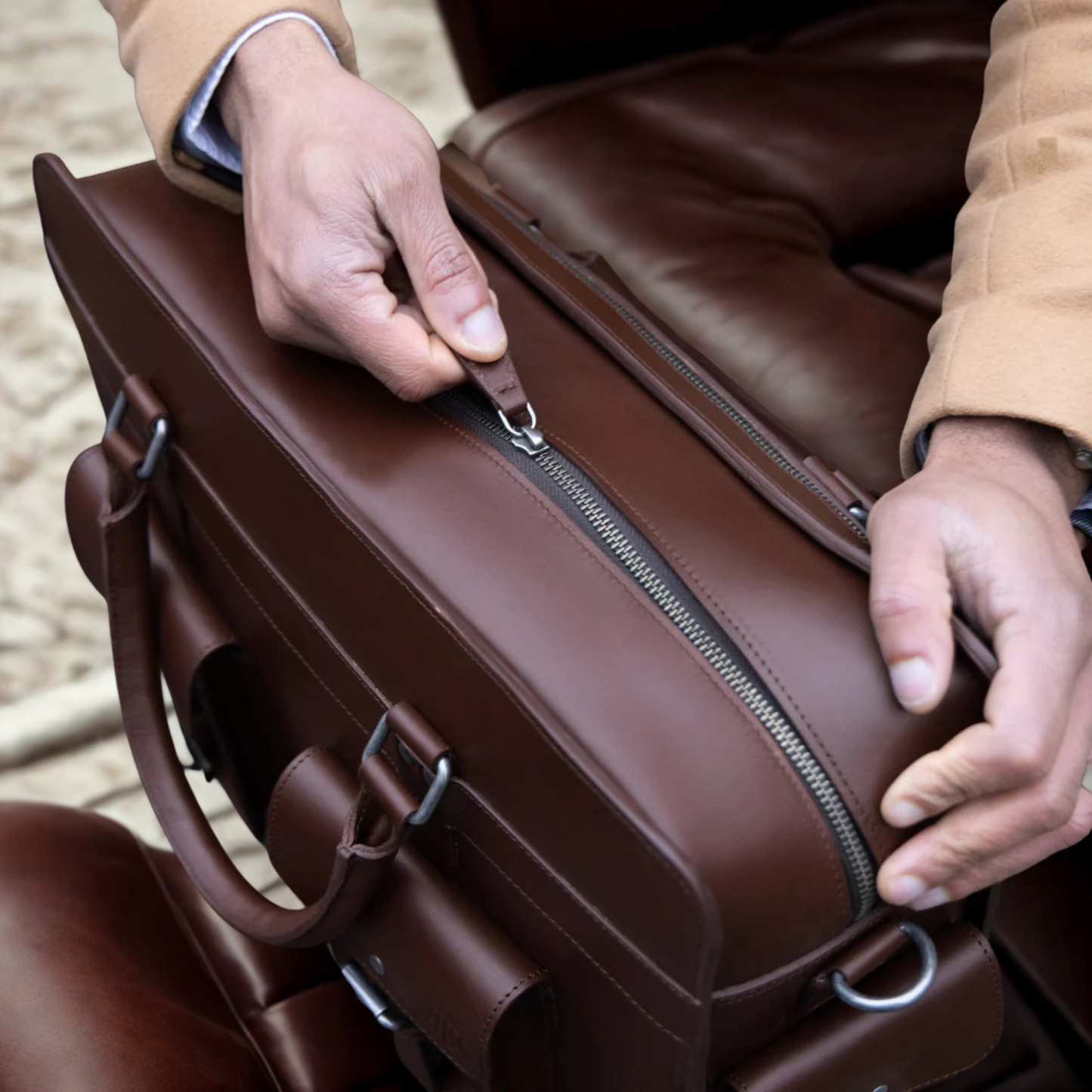 Close-up of premium leather briefcase with waterproof lining and durable zipper.