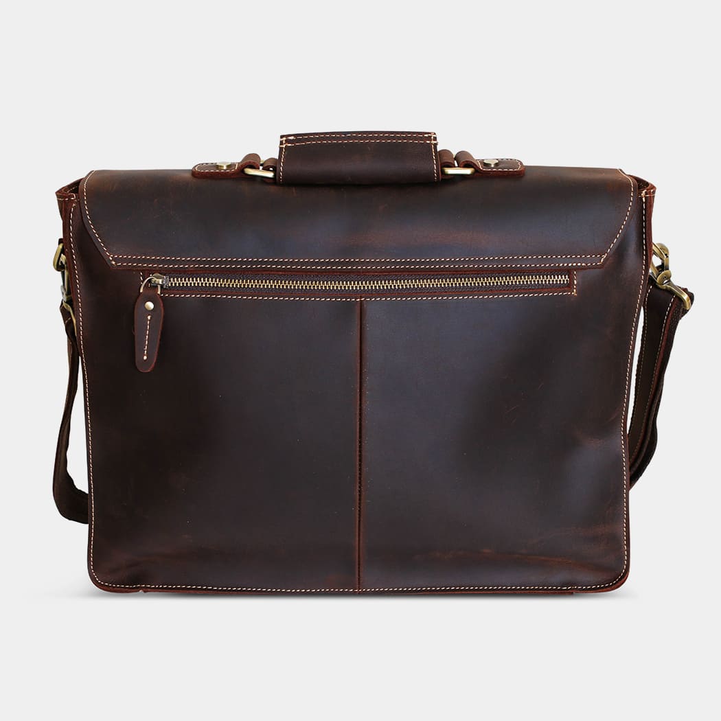 Brown leather briefcase with shoulder strap on a light gray background