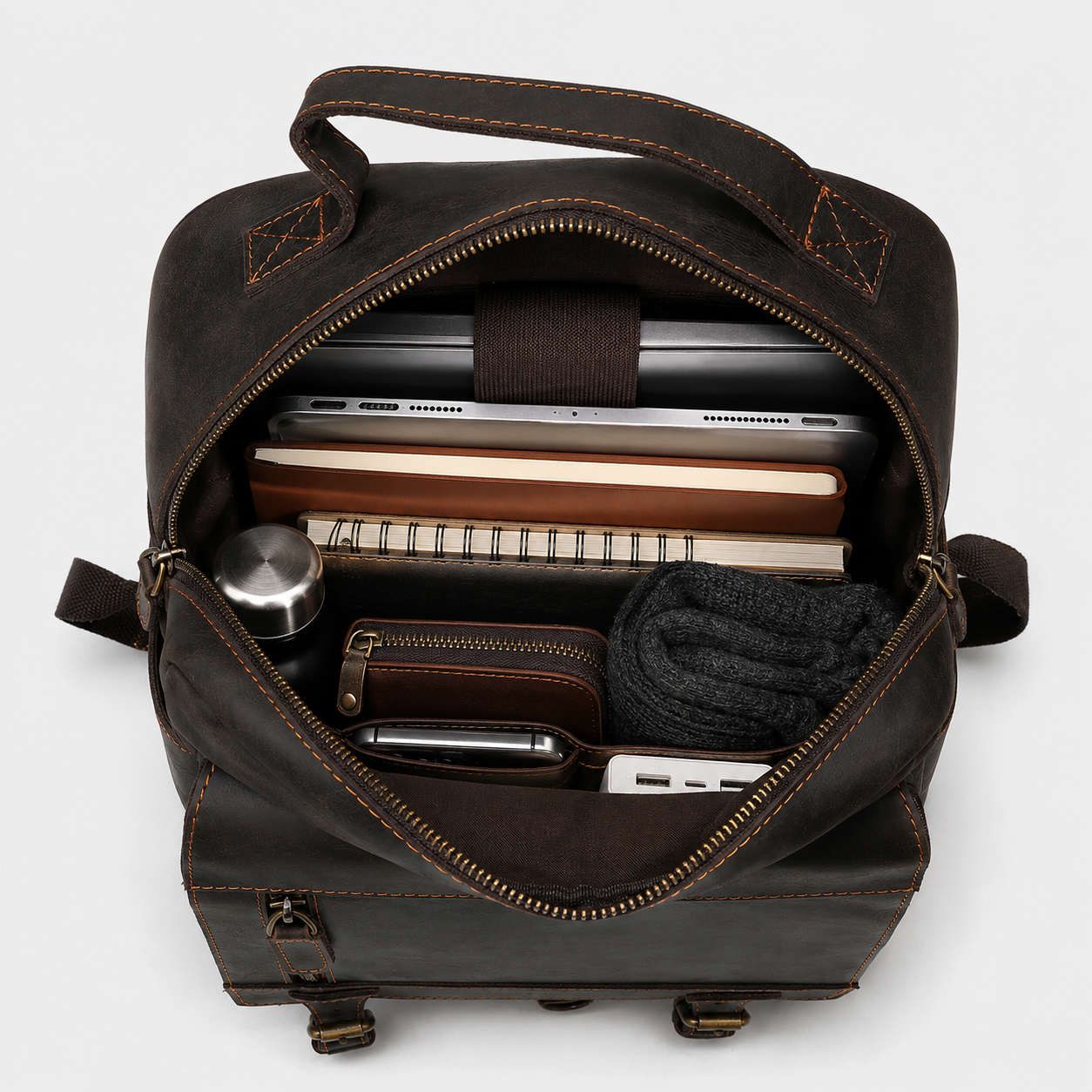 Interior of The District leather backpack showing padded laptop compartment and organized storage