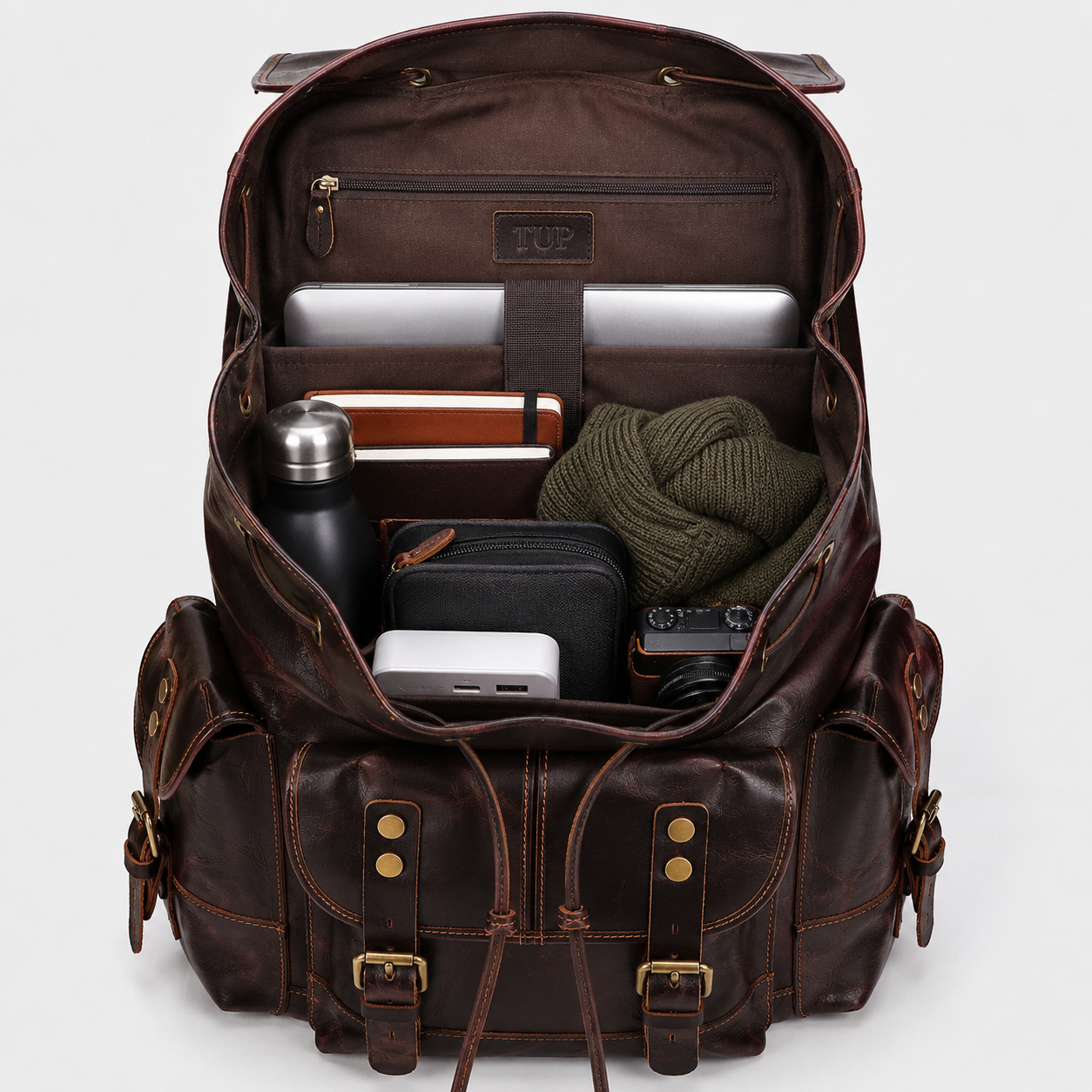 Interior of The Expedition leather backpack showing padded 17-inch laptop compartment and spacious storage