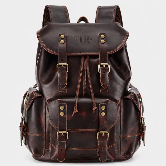 The Expedition full grain leather backpack in dark brown with drawstring closure, buckle straps, and premium brass hardware