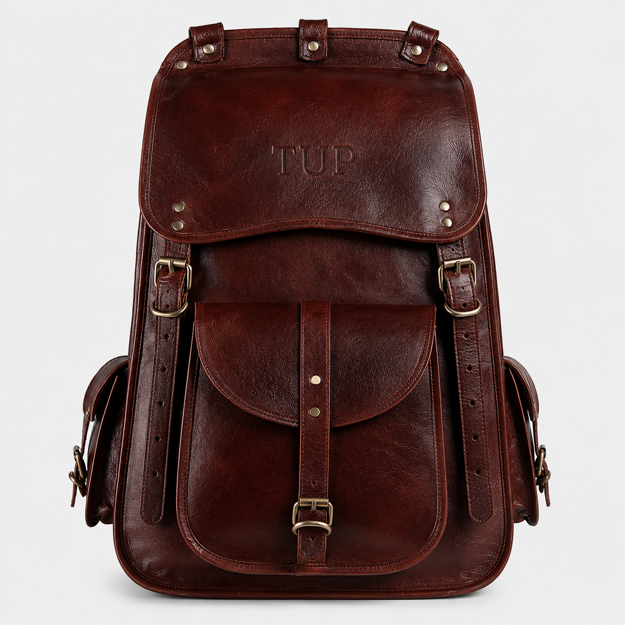 The Frontier full-grain buffalo leather backpack in vintage brown with buckle flap closure and brass hardware