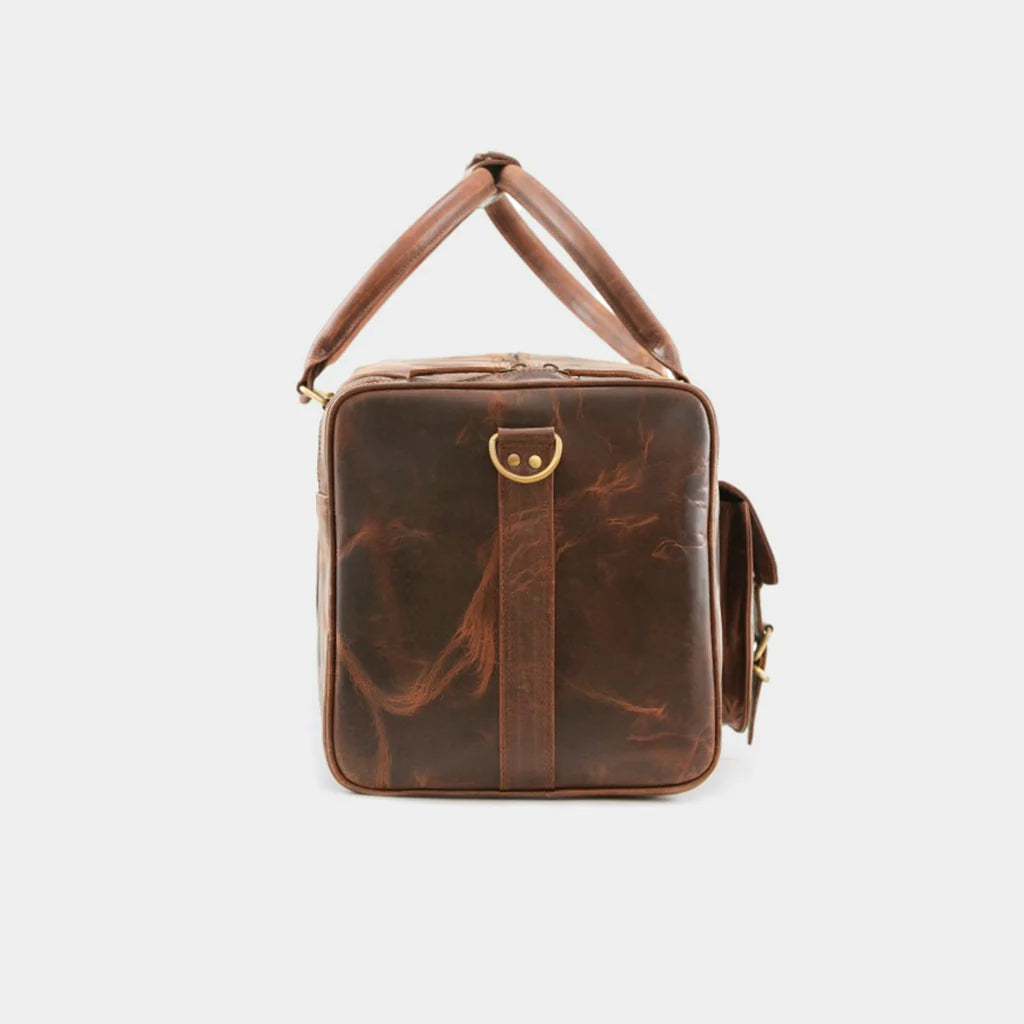 Lifestyle photo of businessman carrying The Grant Duffle leather bag