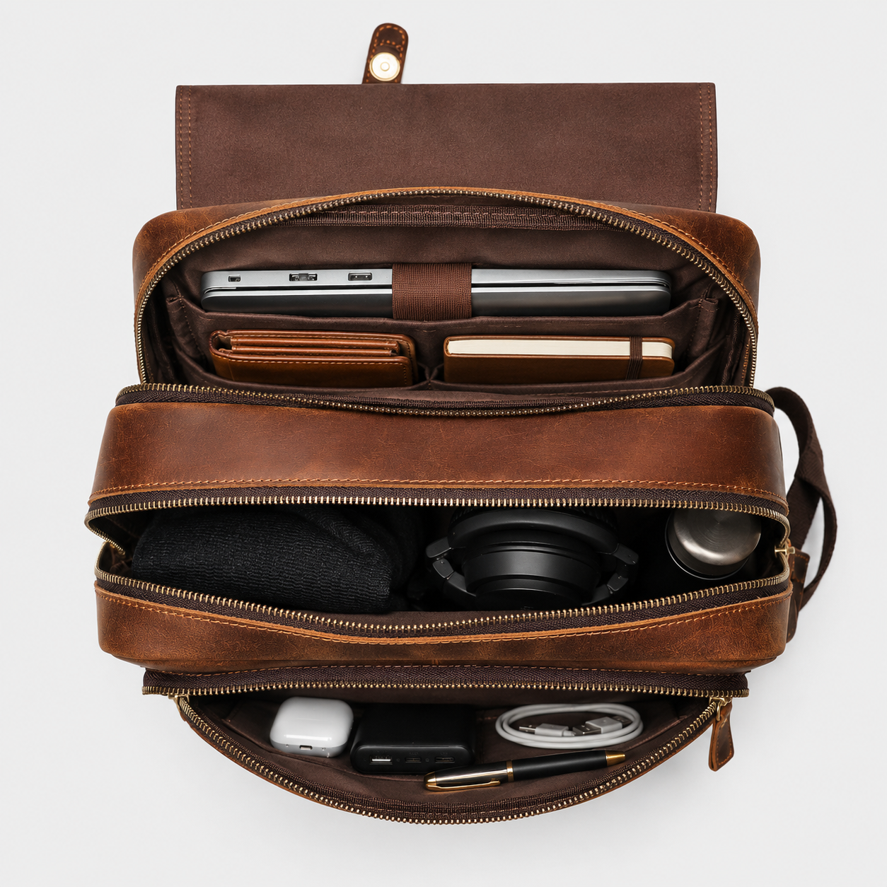 Interior of The Highland leather backpack showing dual compartments and padded laptop sleeve