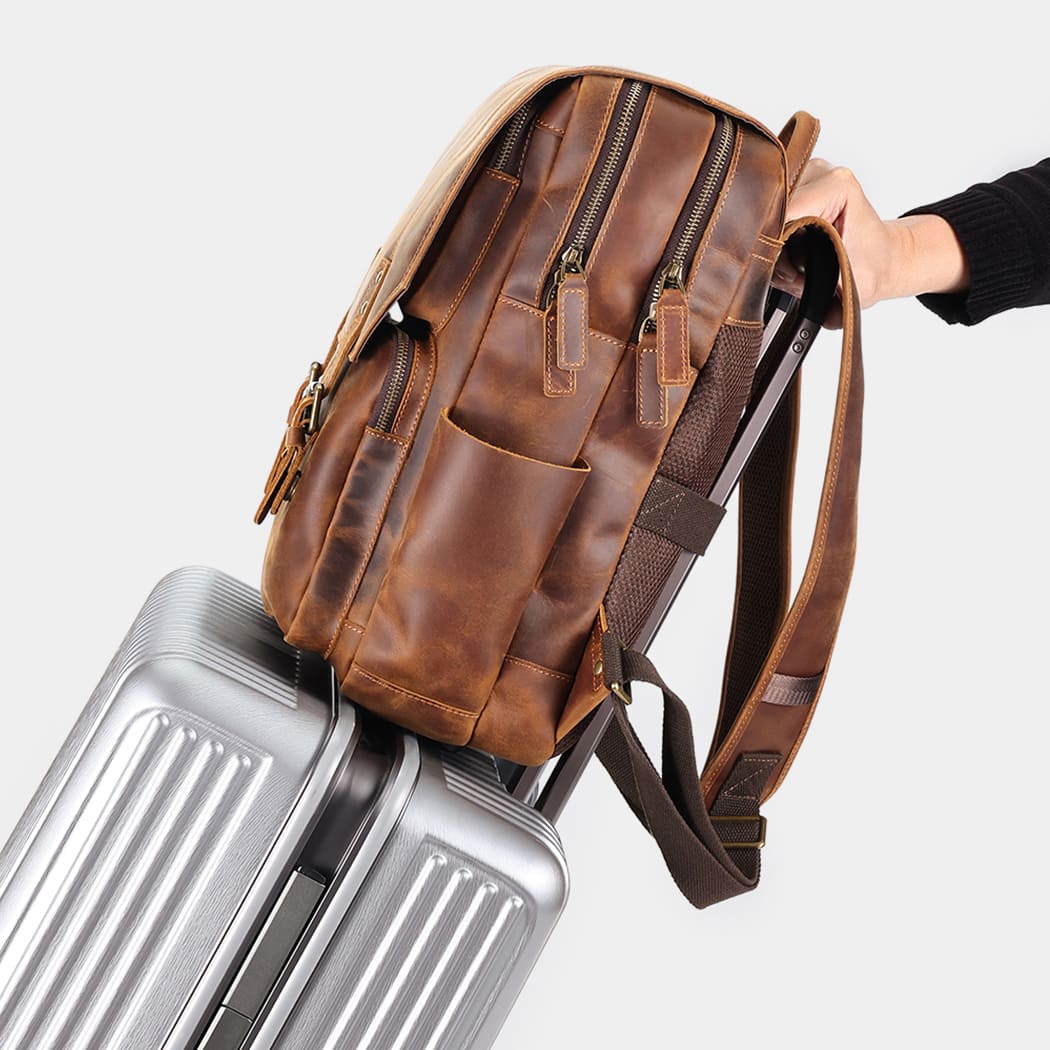 Leather backpack attached to rolling luggage using rear luggage sleeve