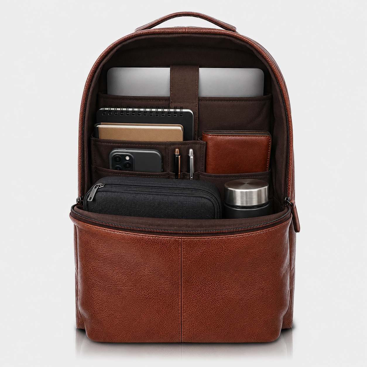 Interior of The Lincoln leather backpack with dual compartments, laptop sleeve, and organizer pockets