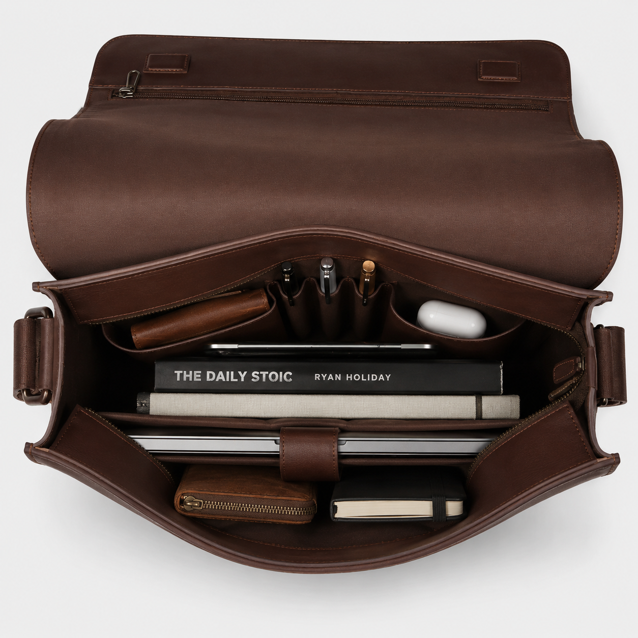Interior view of The Mercer leather briefcase showing padded laptop compartment and organized storage