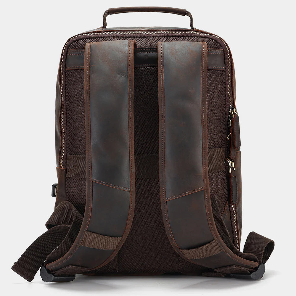 Leather backpack attached to rolling luggage using integrated luggage strap