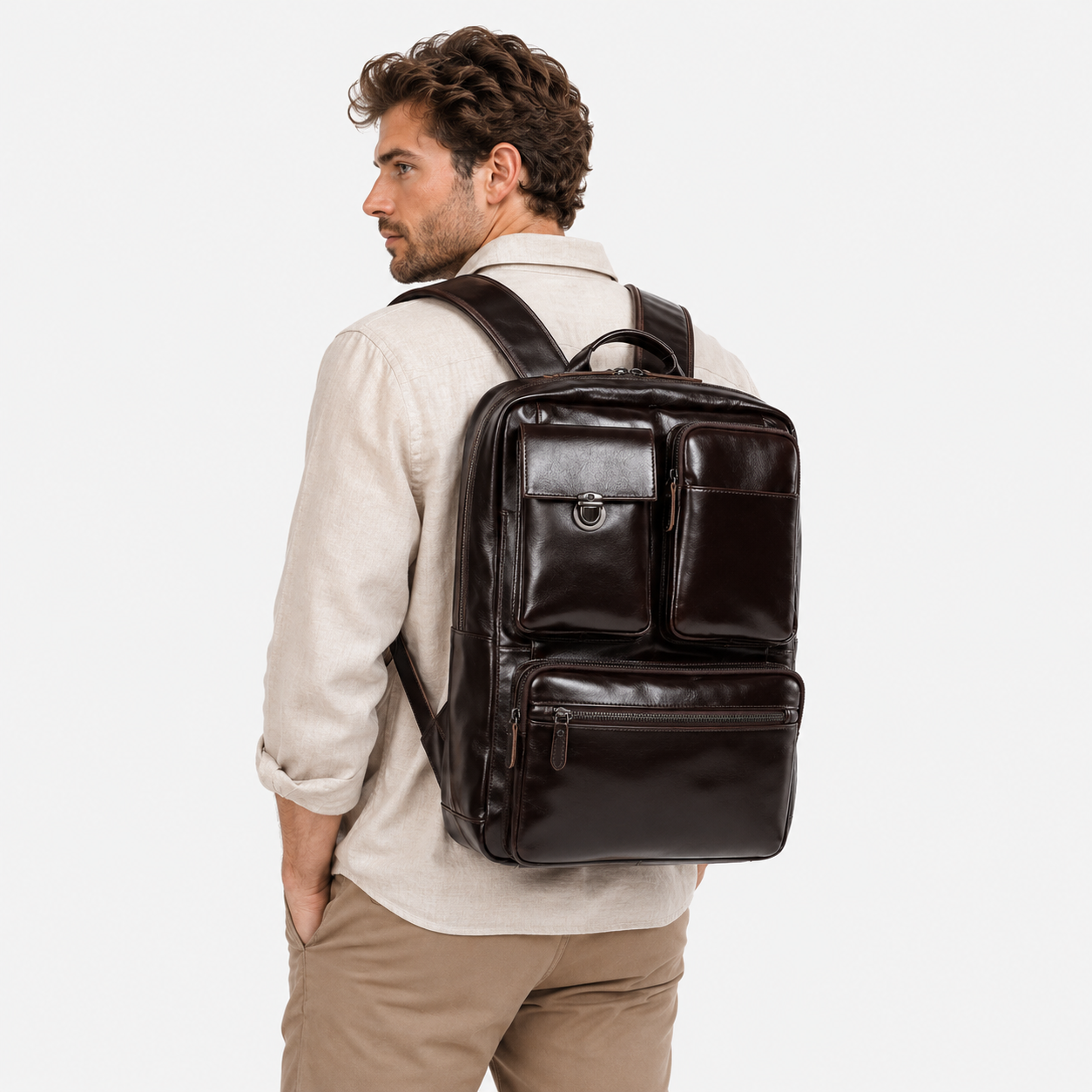 Professional carrying the Voyager Pro convertible leather backpack during business travel